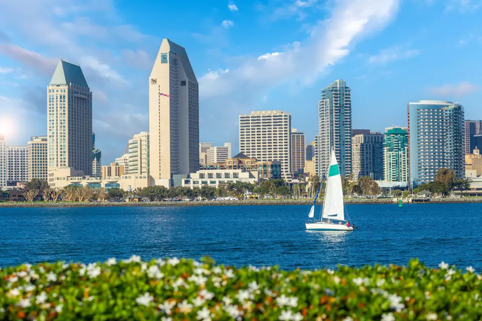 San Diego skyline across the bay with a sailboat in the foreground