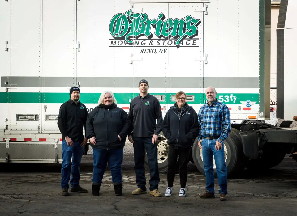 Five members of the O'Brien's team in front of an O'Brien's Moving & Storage truck