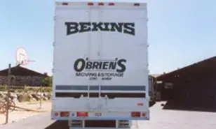 The rear of a truck lettered Bekins and O'Brien's Moving & Storage