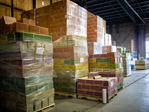 Shrink-wrapped pallets of goods stacked in the O'Brien's warehouse
