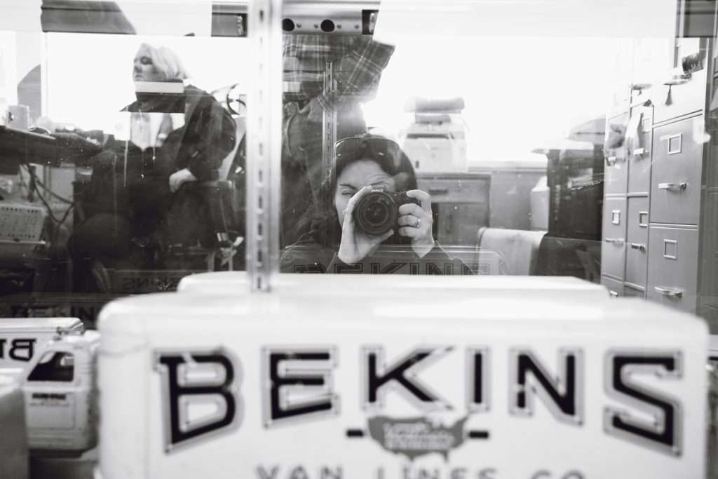 Person taking a picture of a toy Bekins moving truck